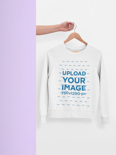 Mockup of a Hanger with a Women's Sweatshirt Mockup Against a Plain Surface