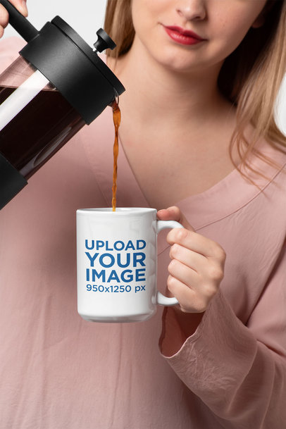 Mockup of a Woman Pouring Coffee in a 15 Oz Mug