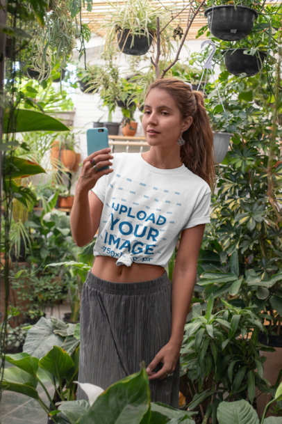 Knotted T-Shirt Mockup of a Bohemian Woman Posing by Some Plants