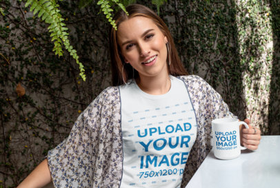 15 oz Mug Mockup of a Woman Wearing a T-Shirt Against a Wall Covered in Leaves 27508