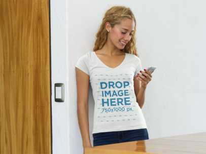 Young Woman at Home Using an iPhone T-Shirt Mockup