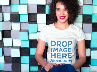 Woman Leaning on a Colorful Modern Wall T-Shirt Mockup
