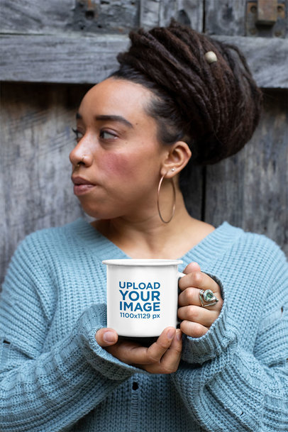Mockup of a Woman with Beehive Hairstyle Holding a 12 Oz Enamel Mug
