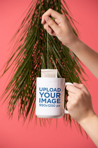 Mockup of a Hand Infusing Tea into a 15 Oz Mug