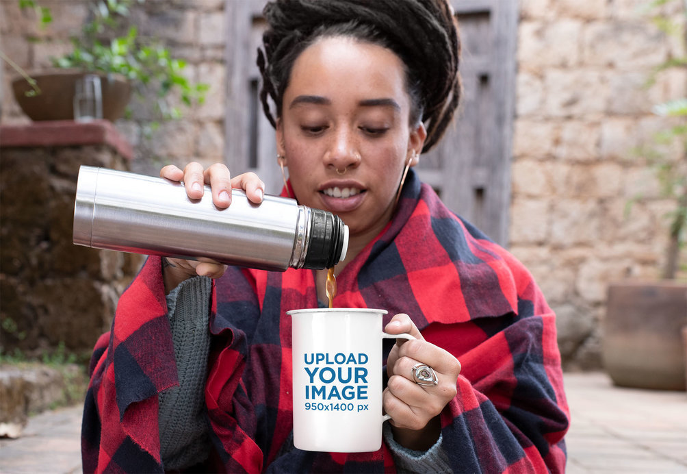Mockup of a Woman with a Checkered Blanket Pouring Coffee into a 21 oz Enamel Mug