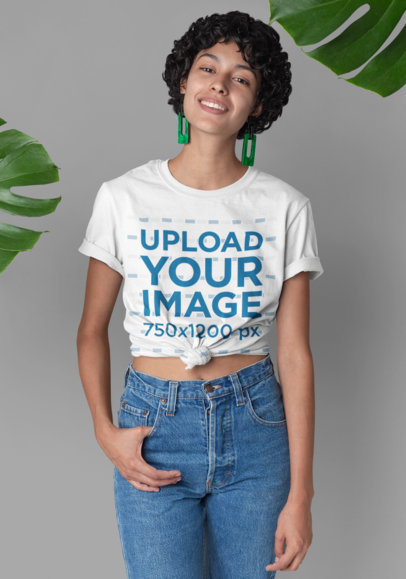 Knotted T-Shirt Mockup Featuring a Woman with Curly Hair and a Tropical Background