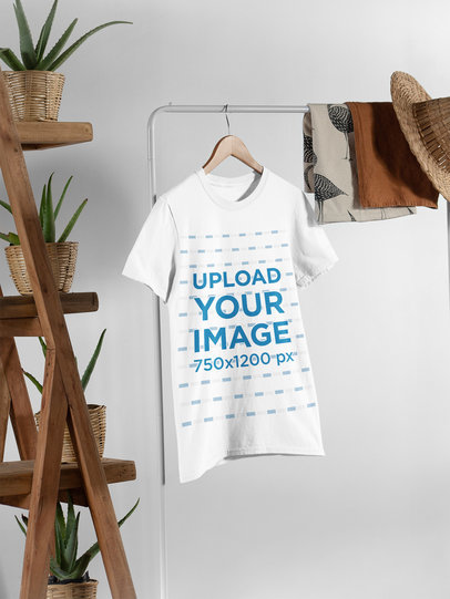 Tee Mockup Hanging from a Rack Next to Wooden Furniture with Plant Pots 27400