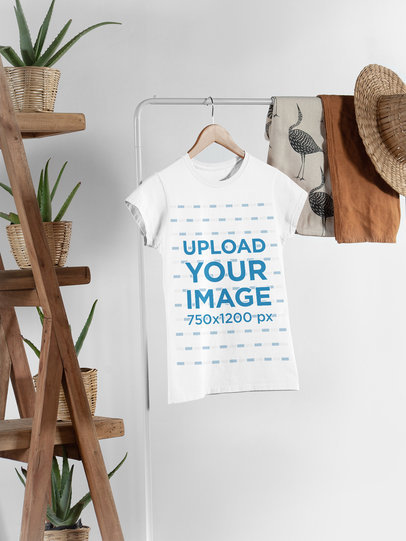 Mockup of a Women's T-Shirt Hanged Next to Some Plant Pots and Other Garments 27395