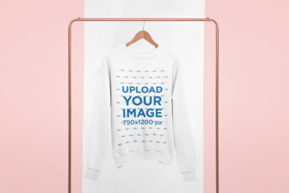 Crewneck Sweatshirt Mockup Hanging from a Copper Clothing Rack 