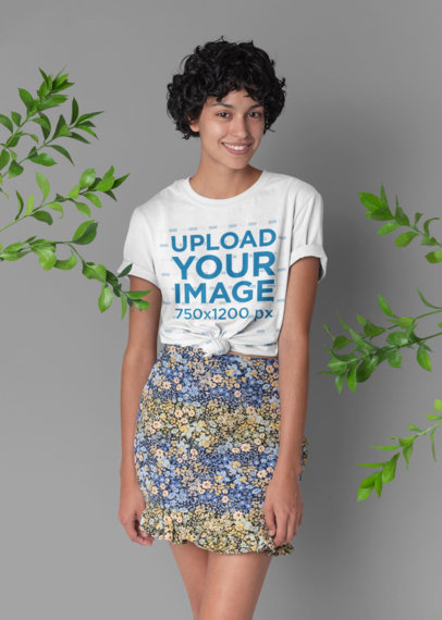 Knotted Tee Mockup Featuring a Woman with Short Hair Surrounded by Some Plants