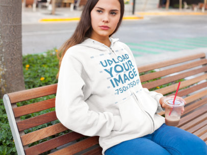 Hoodie Mockup of a Girl at a Park Having an Iced Coffee a7888