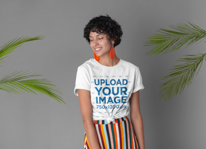 Knotted Tee Mockup Featuring a Woman Surrounded by Palm Leaves 