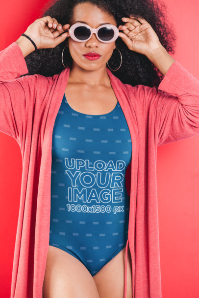 Mockup of a Woman with Sunglasses Wearing a One-Piece Swimsuit Under a Robe