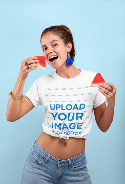 Knotted T-Shirt Mockup Featuring a Joyful Woman Holding Two Watermelon Slices