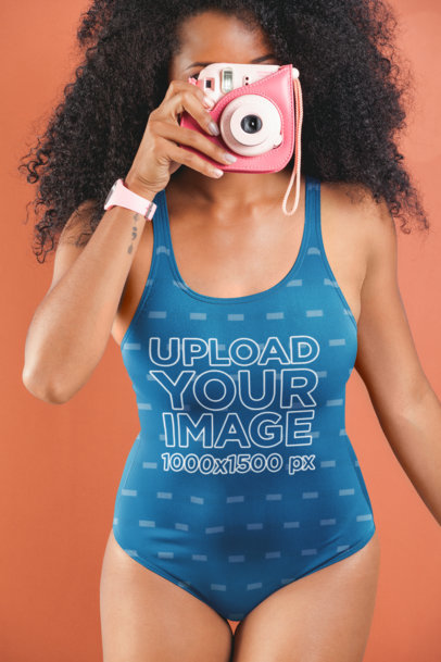 Swimsuit Mockup of a Woman Taking a Photo with a Retro Polaroid Camera 26570