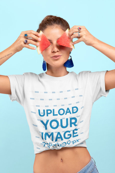 Knotted T-Shirt Mockup Featuring a Woman Covering Her Eyes with Two Watermelon Slices