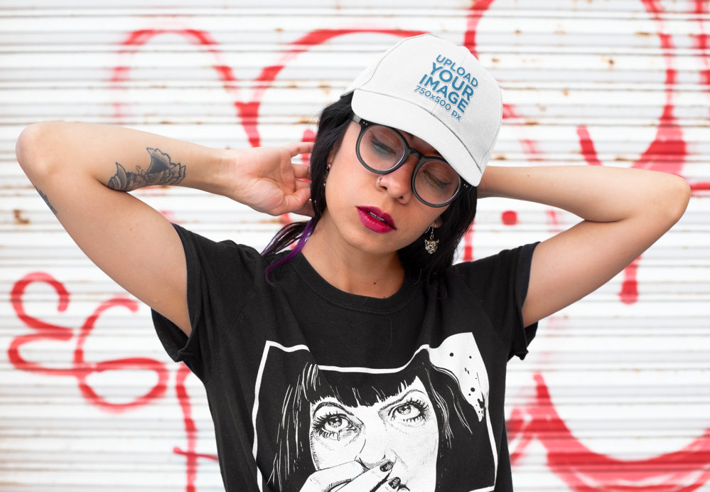 Dad Hat Mockup Featuring a Woman Posing Against a Graffiti Wall