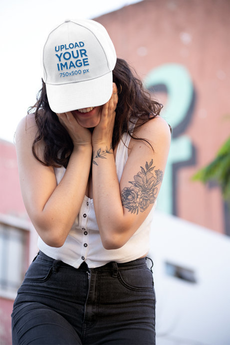 Dad Hat Mockup Featuring a Smiling Woman Hiding Her Eyes 