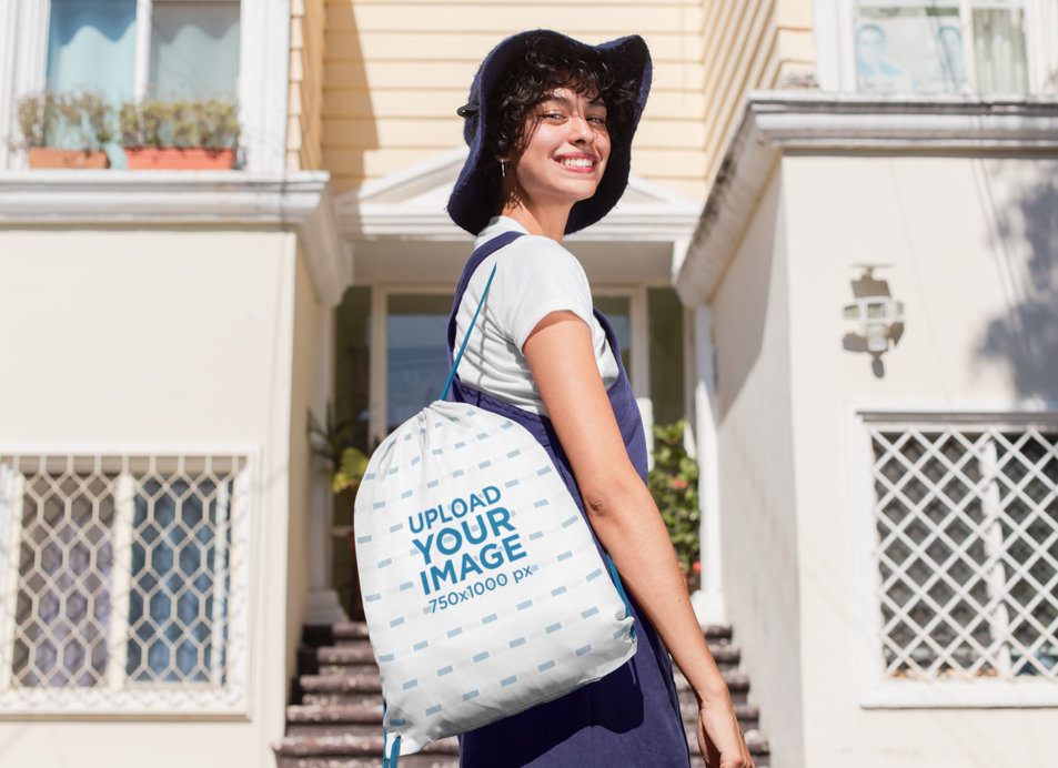 Drawstring Bag Mockup Featuring a Stylish Woman Standing  in Front of a House