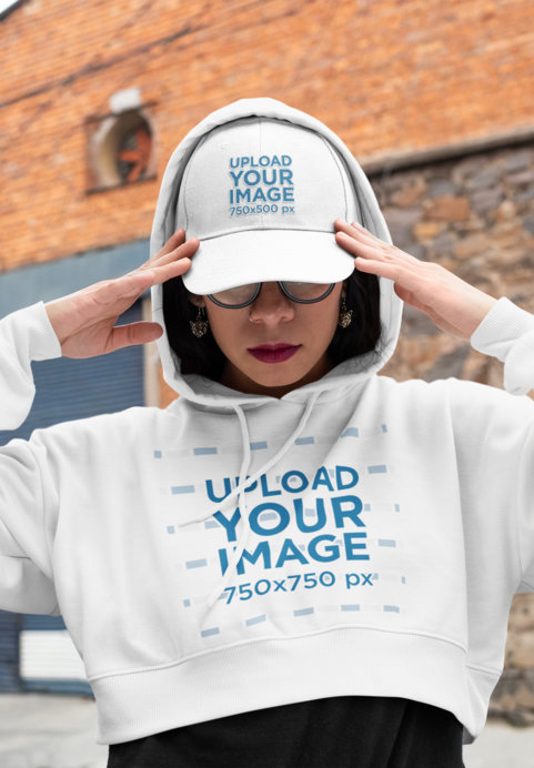 Mockup of an Edgy Woman Wearing a Crop Top Hoodie and a Dad Hat