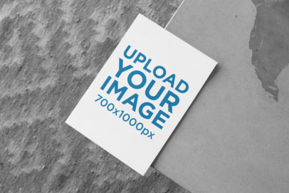 Mockup of an A5 Flyer Lying on a Textured Gray Surface 