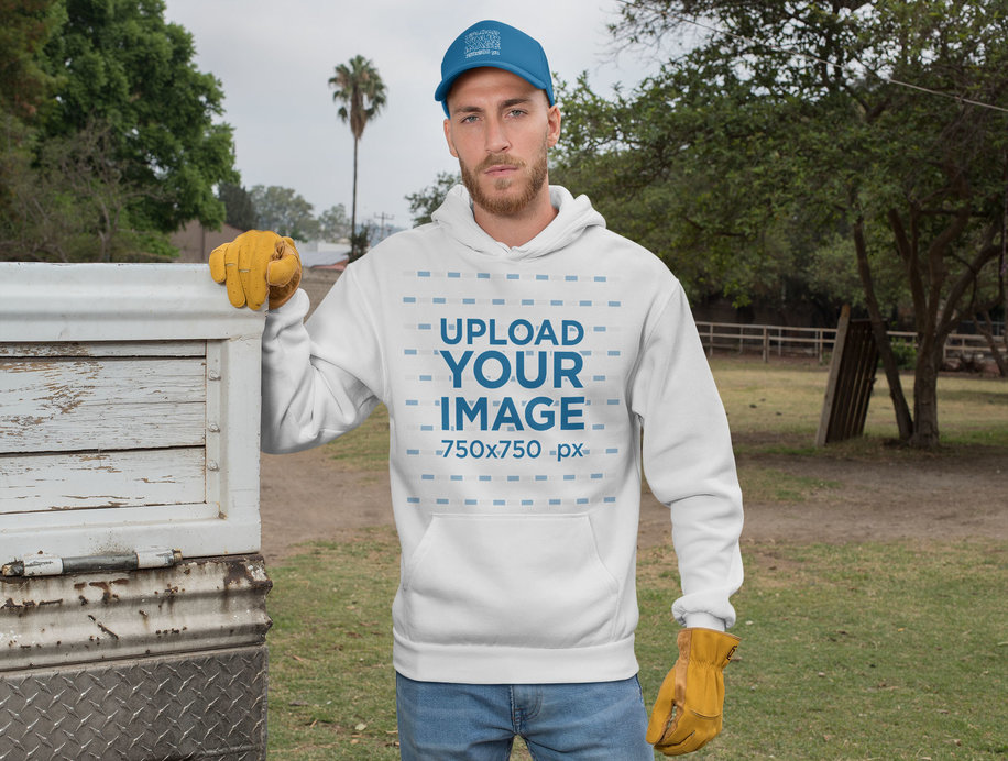 Mockup of a Ranch Worker Wearing a Hoodie and a Trucker Cap