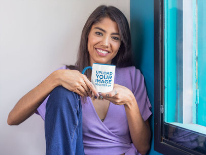 Mockup Featuring a Long-Haired Woman Holding an 11 oz Two-Toned Mug by a Window