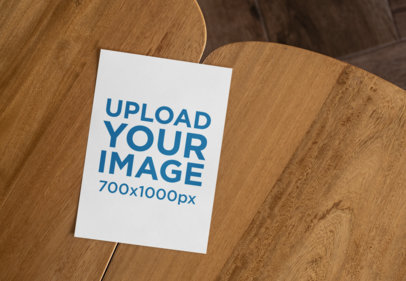 Mockup of an A6 Postcard on a Wooden Table