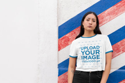 Ringer Tee Mockup Featuring a Girl Against a Color-Striped Wall