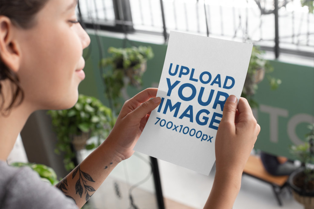 Mockup of a Woman Reading an A5 Flyer 