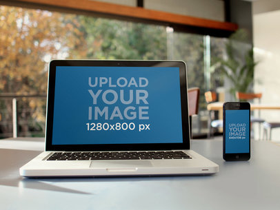 Mockup of a MacBook and a Samsung Galaxy at a Cafe