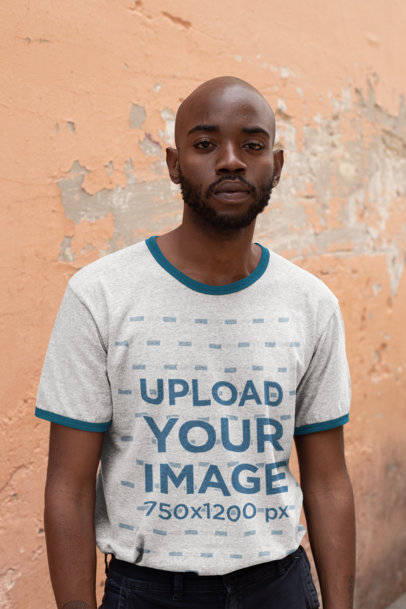 Ringer T-Shirt Mockup Featuring a Bearded Man Against an Old Wall