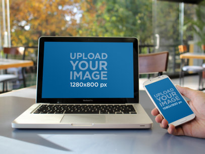 Mockup of a Someone Using a MacBook and a Samsung Galaxy at a Cafe