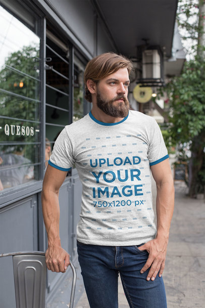 Ringer T-Shirt Mockup Featuring a Bearded Man Outside a Restaurant