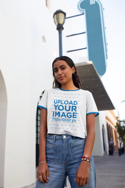 Ringer T-Shirt Mockup of a Young Woman Standing on a Sidewalk 27264