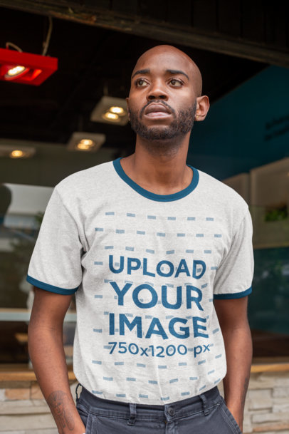 Ringer T-Shirt Mockup Featuring a Serious-Looking Young Man 