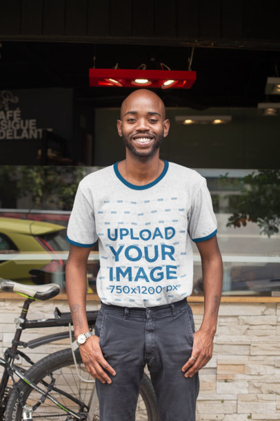 Ringer T-Shirt Mockup of a Smiling Man Standing on the Sidewalk