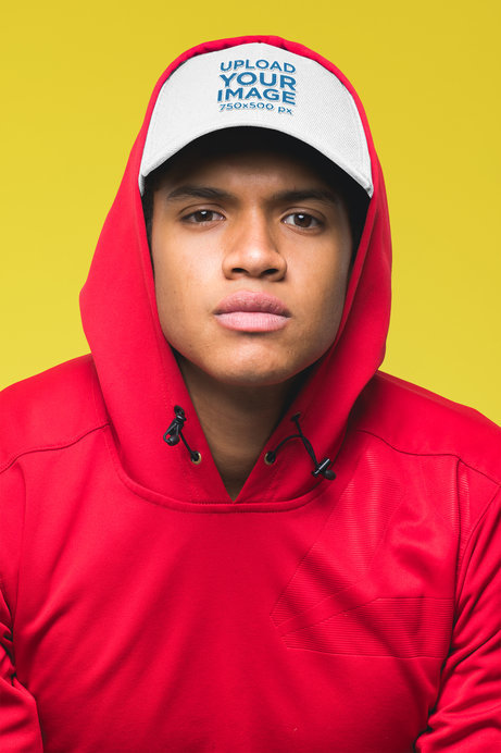Mockup of a Serious Looking Young Man Covering His Dad Hat