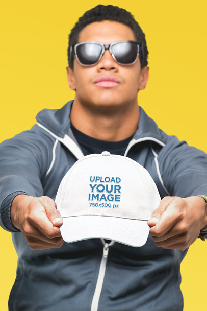 Dad Hat Mockup Featuring a Young Man with Sunglasses at a Studio 