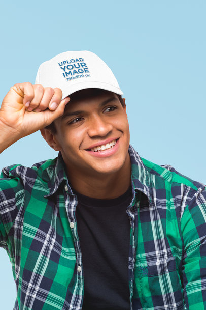 Mockup of a Man Grabbing His Dad Hat in a Studio