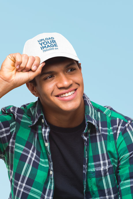 Mockup of a Man Grabbing His Dad Hat in a Studio
