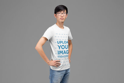 T-Shirt Mockup Featuring a Man Proudly Posing Against a Plain Background