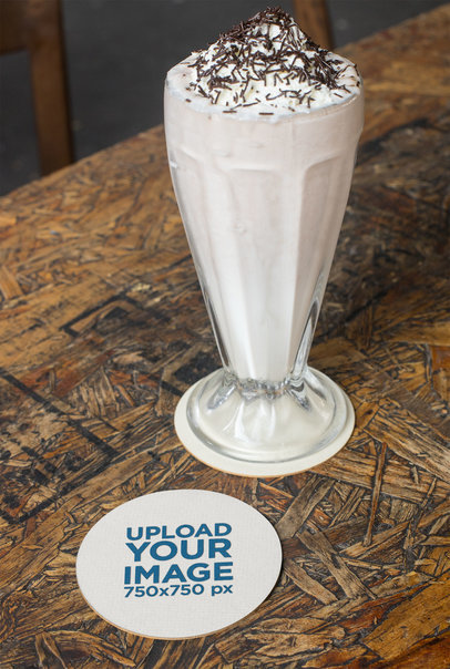 Coaster Mockup Featuring a Wooden Surface and a Milkshake 