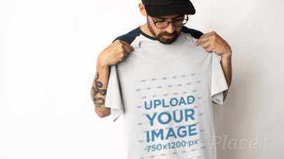 Video of a Bearded Man Holding a T-Shirt Against His Chest