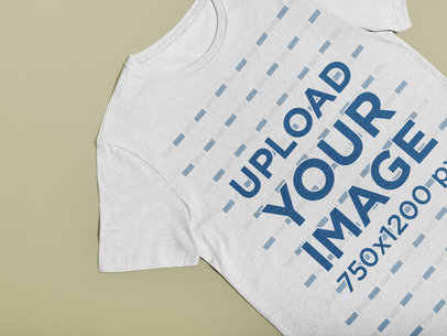 Minimal Mockup of a Heather T-Shirt Lying on a Solid Color Surface 