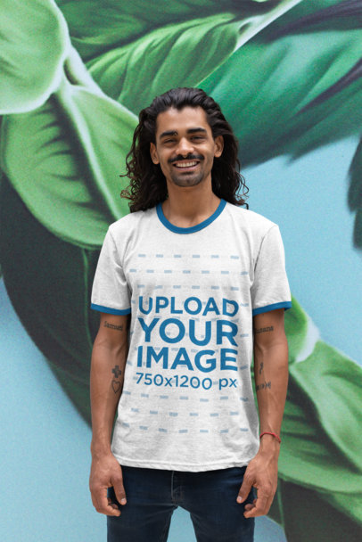 Ringer T-Shirt Mockup of a Man Against a Tropical Leaves Wallpaper