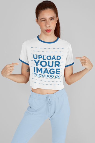 Ringer T-Shirt Mockup Featuring a Woman Winking and Pointing at Her Shirt 