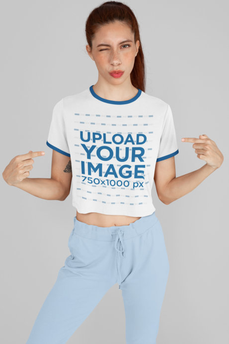 Ringer T-Shirt Mockup Featuring a Woman Winking and Pointing at Her Shirt 