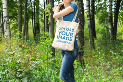 Tote Bag Mockup Featuring a Woman Walking in the Woods 22-el