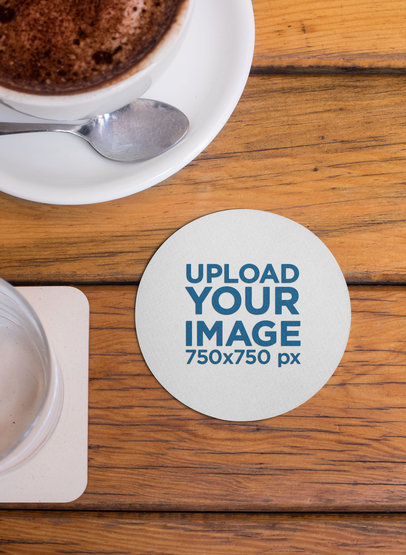 Mockup of a Round Coaster Placed Next to a Cup of Hot Chocolate